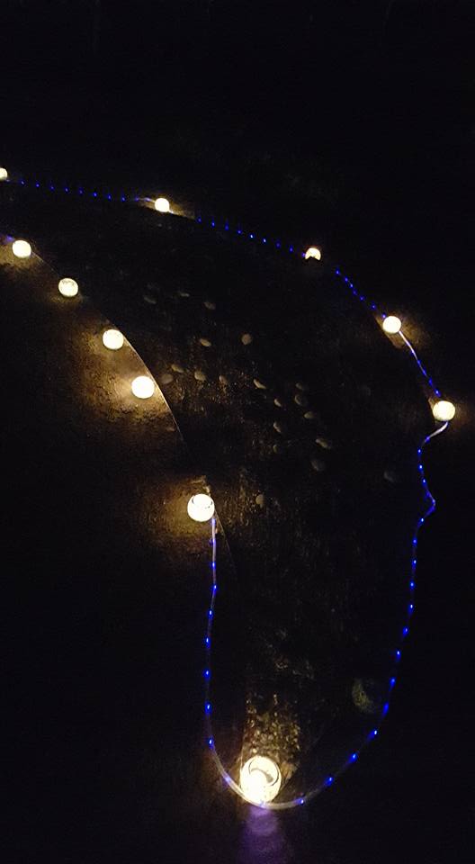 Candles lining the moon bed in the dark